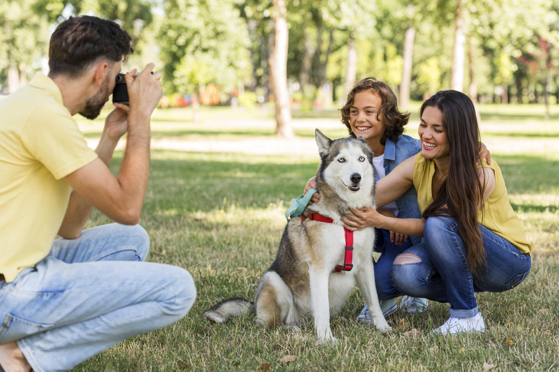 father-taking-pictures-mother-son-with-dog-park father-taking-pictures-mother-son-with-dog-park