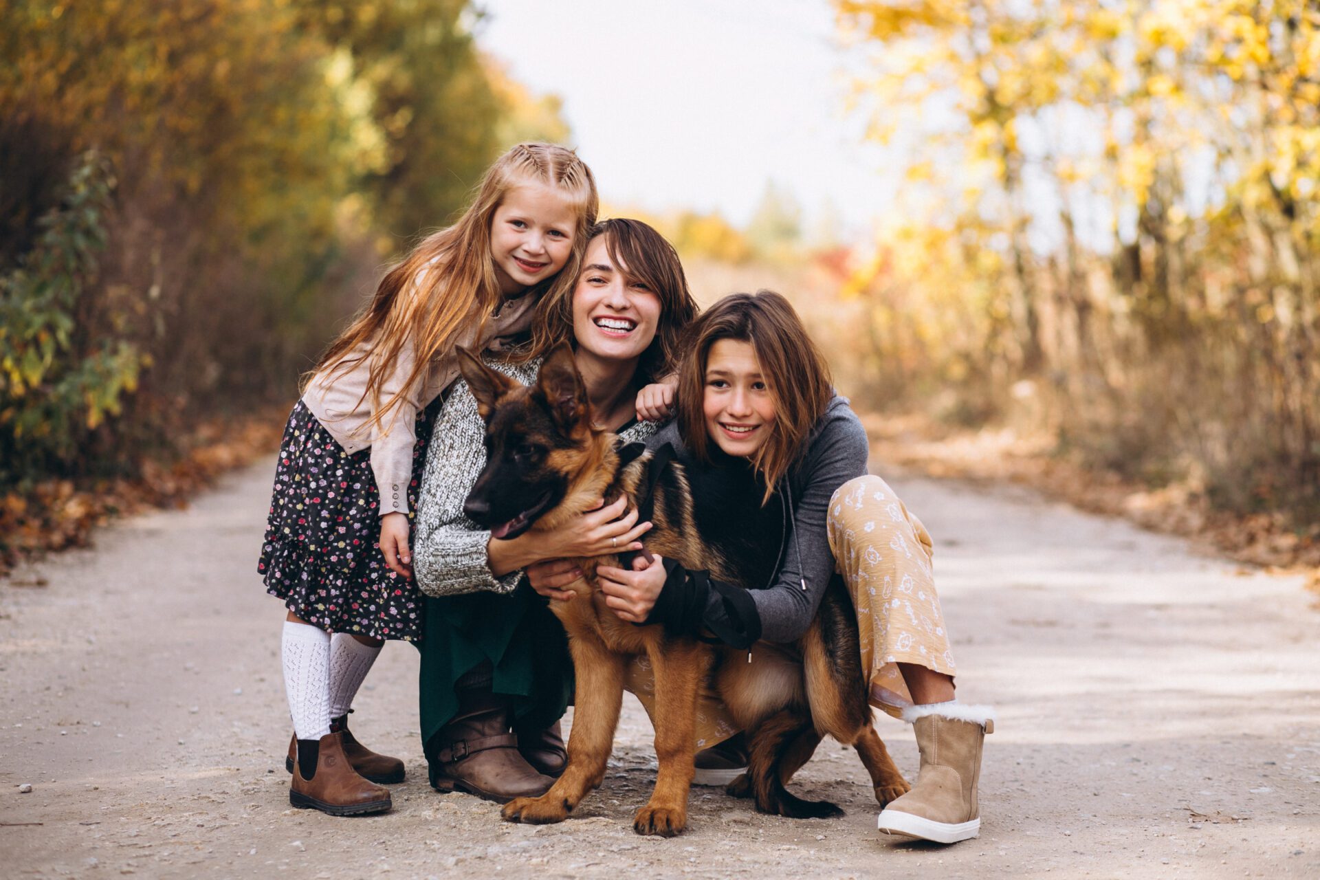 Mother with kids and dog in an autumn park Mother with kids and dog in an autumn park